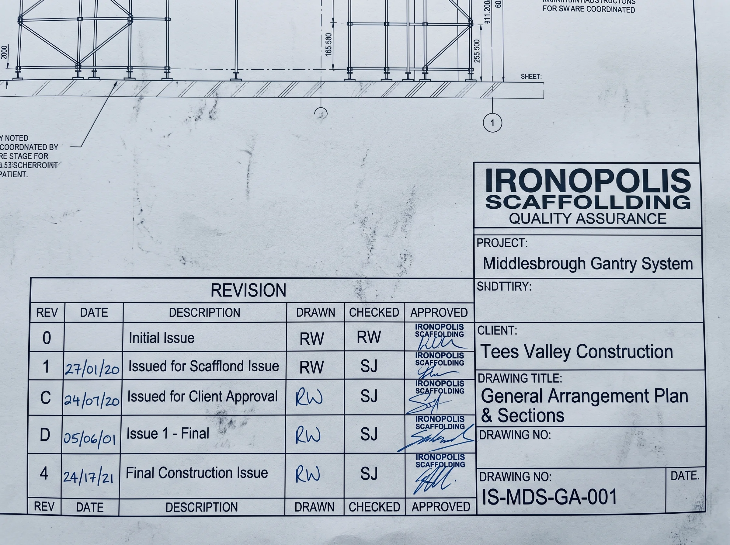 Close-up of a scaffold drawing title block showing revision letters, checked-by initials and issue date